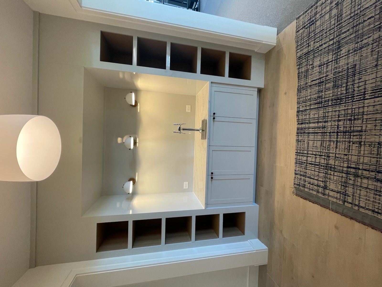 Built-in beverage bar with flanking open shelving towers and stone countertop