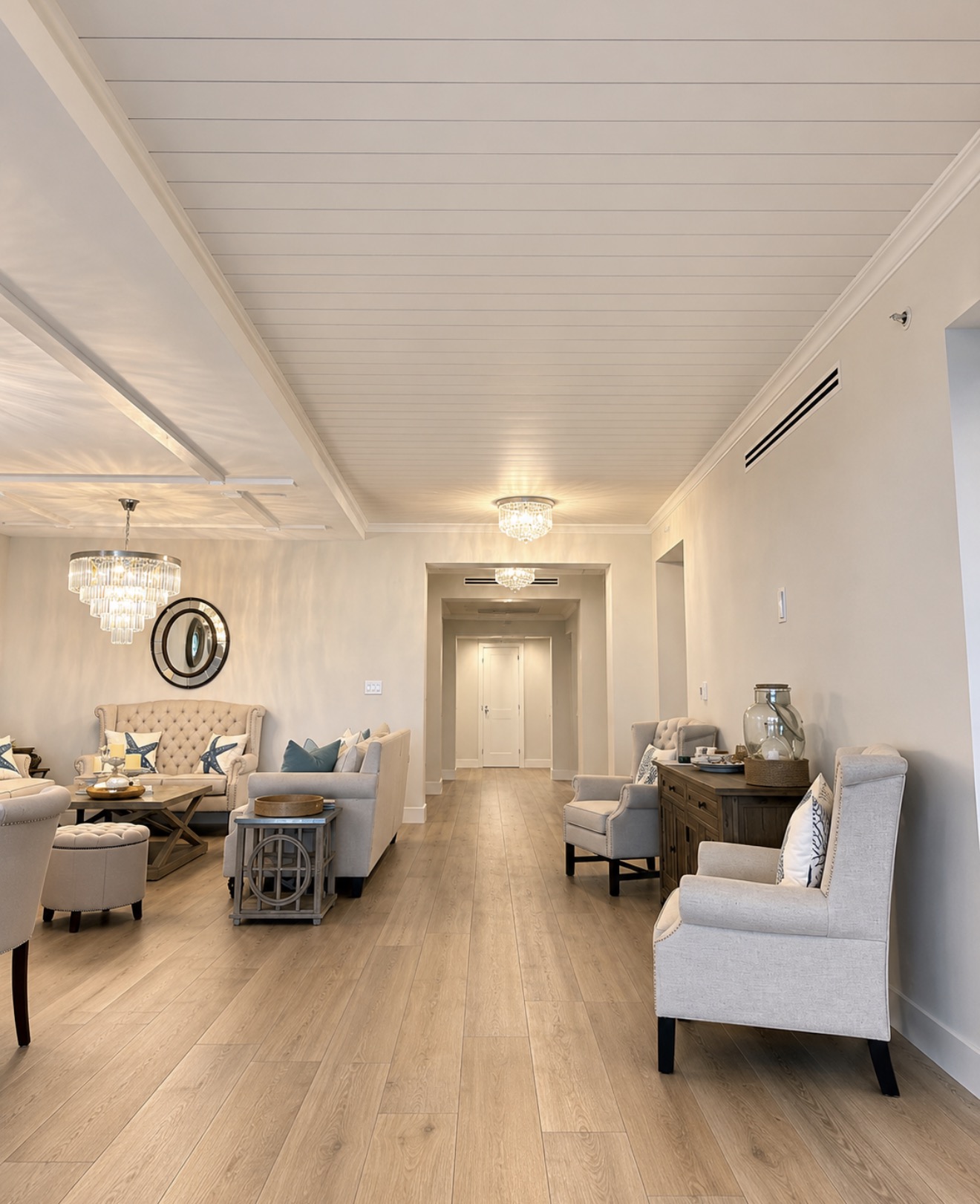 Open living and dining area with completed shiplap ceiling paneling and beam detail