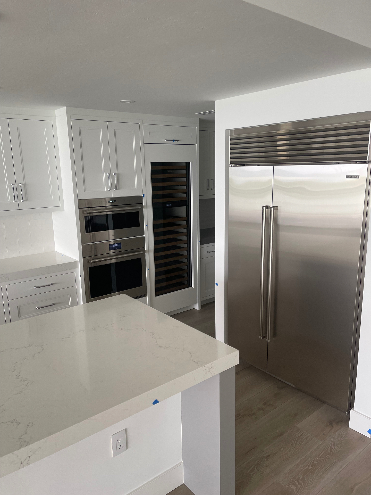 Custom wine display and service cabinetry with glass fronts by ARTEC Woodworkers in Naples, Florida