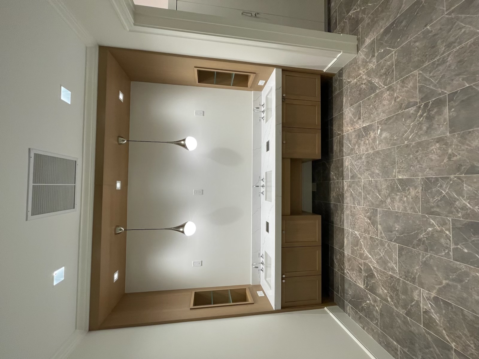 Custom vanity cabinetry with architectural stone surround by ARTEC Woodworkers in Naples, Florida