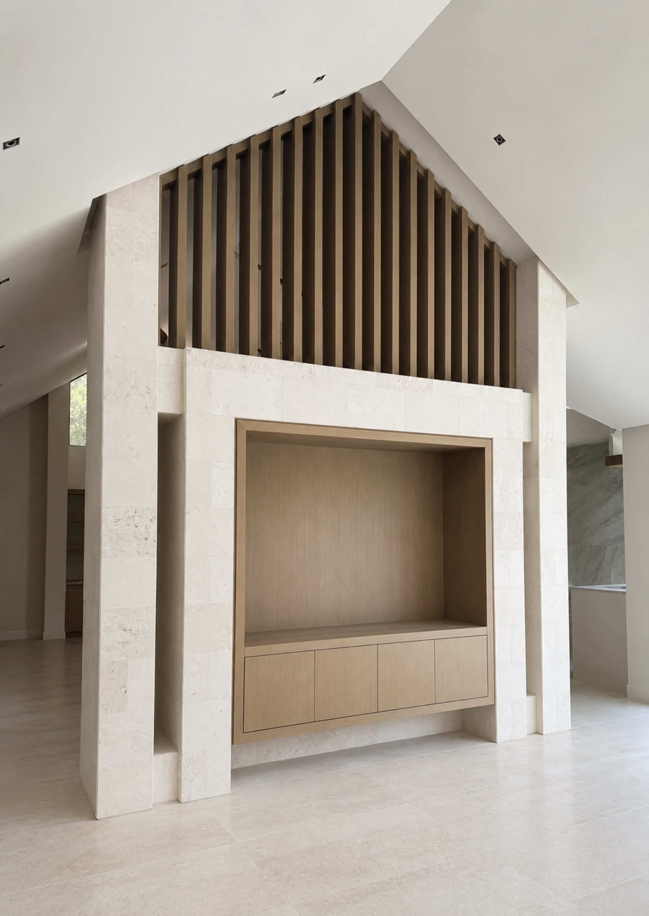 White oak slatted millwork and stone surround built-in composition by ARTEC Woodworkers in Naples, Florida