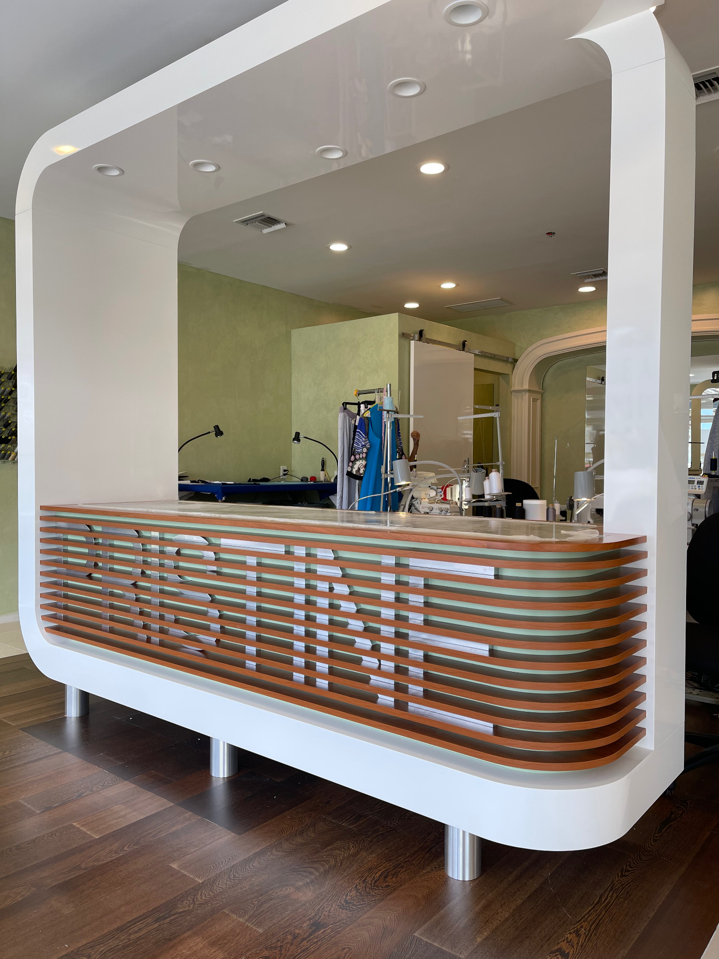 Commercial interior with curved millwork openings and integrated reception element by ARTEC Woodworkers