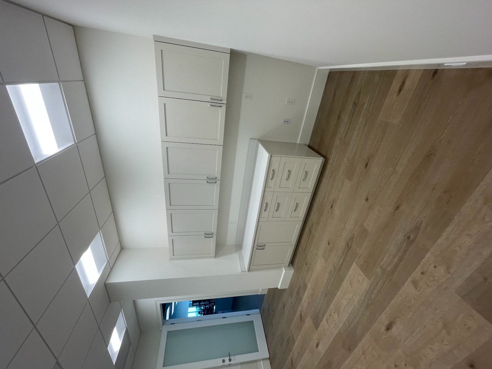 Custom office cabinetry with upper wall cabinets and base drawer bank