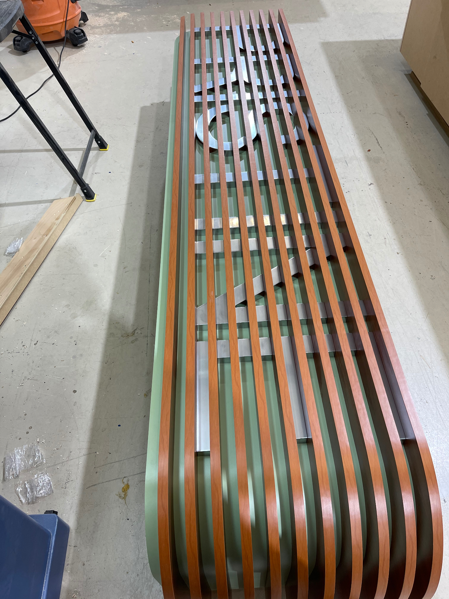 Curved laminated wood slat millwork panel under fabrication in the ARTEC Woodworkers shop